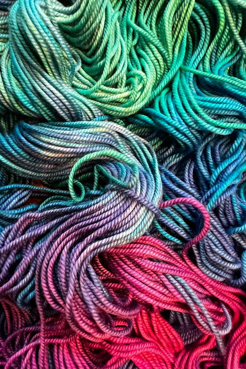Bohemian Rhapsody hand dyed yarn in greens, blues, purples and shocking magenta. Dyed in Minnepolis.