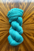 Hand dyed in Minneapolis to mix with Masterpiece collection Teal 100g merino yarn.