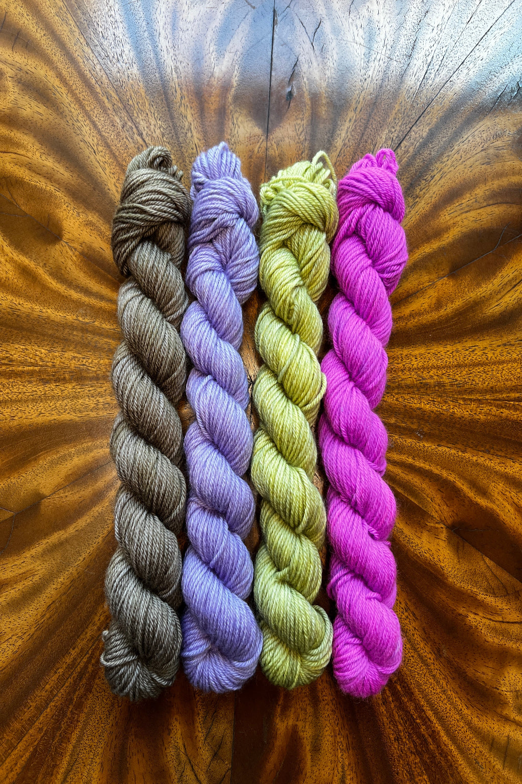 Four 20g mini skeins of yarn hand dyed in Minneapolis to coordinate with Primavesi Masterpiece collection Olive Brown, Purple Pop, Lichen and Lavender