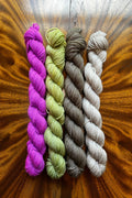 Mini skein set hand-dyed in Minneapolis in Purple Pop, Lichen, Olive Brown and Driftwood. Inspired by Summer Haze Masterpiece Collection.