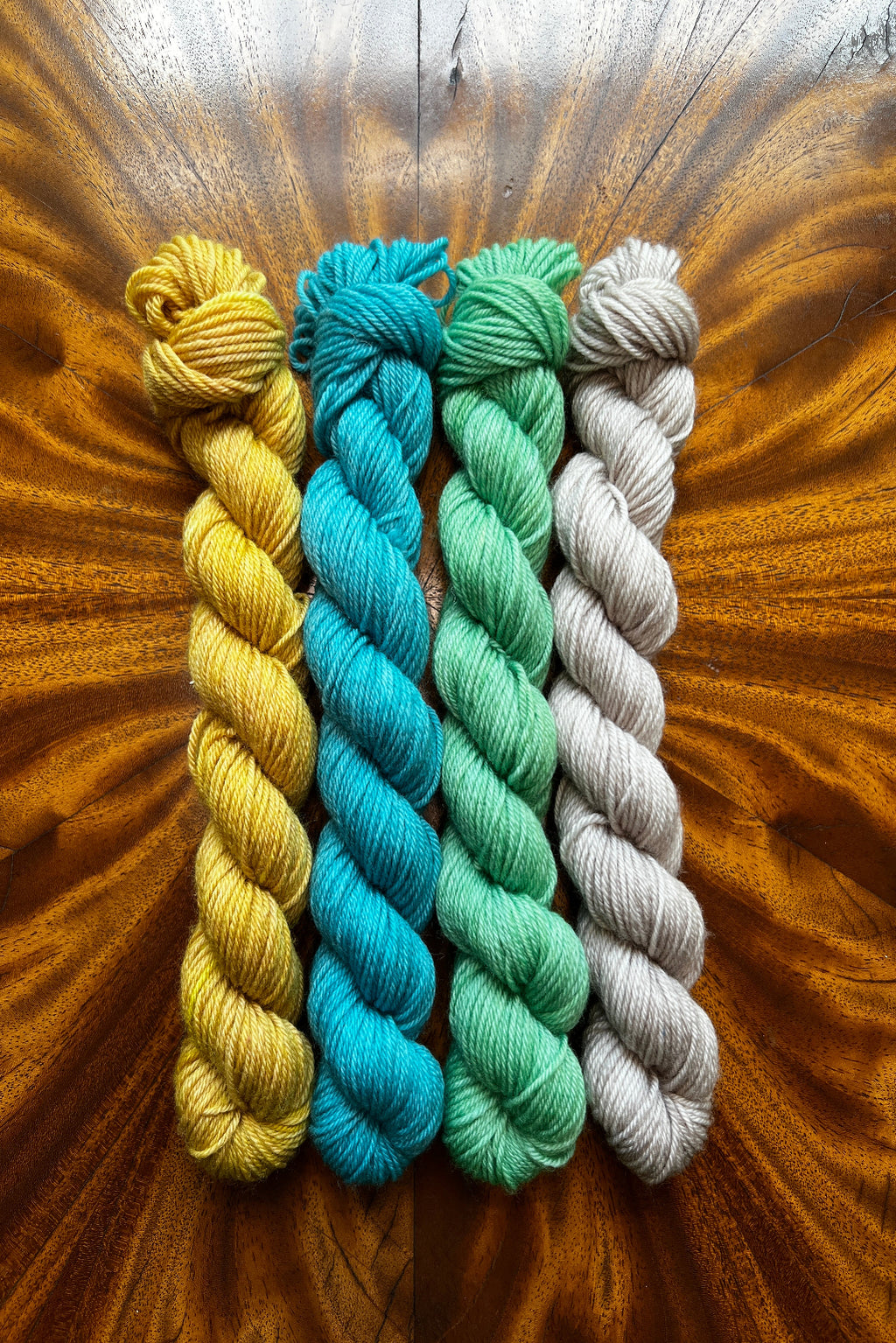 Set of four 20-gram hand dyed mini skeins in tonal hand-dyed yarn colorways designed to coordinate with The Painted Skein’s Van Gogh's Roses Masterpiece Collection.