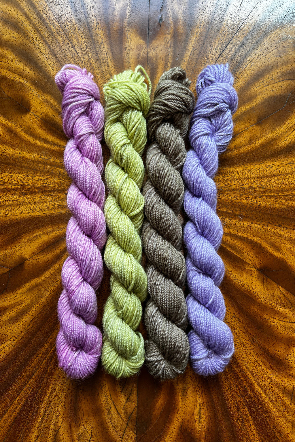 Set of four hand dyed 20-gram mini skeins in tonal hand-dyed yarn colorways designed to coordinate with The Painted Skein’s Monet Sunrise Masterpiece Collection.