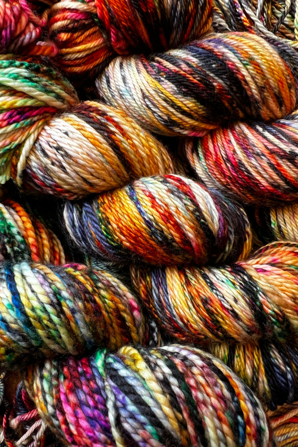 Lady with Fan Colorway hand-dyed in Minneapolis, in gold, red, blue, green, and black tones. Painted Skein Masterpiece Collection. 