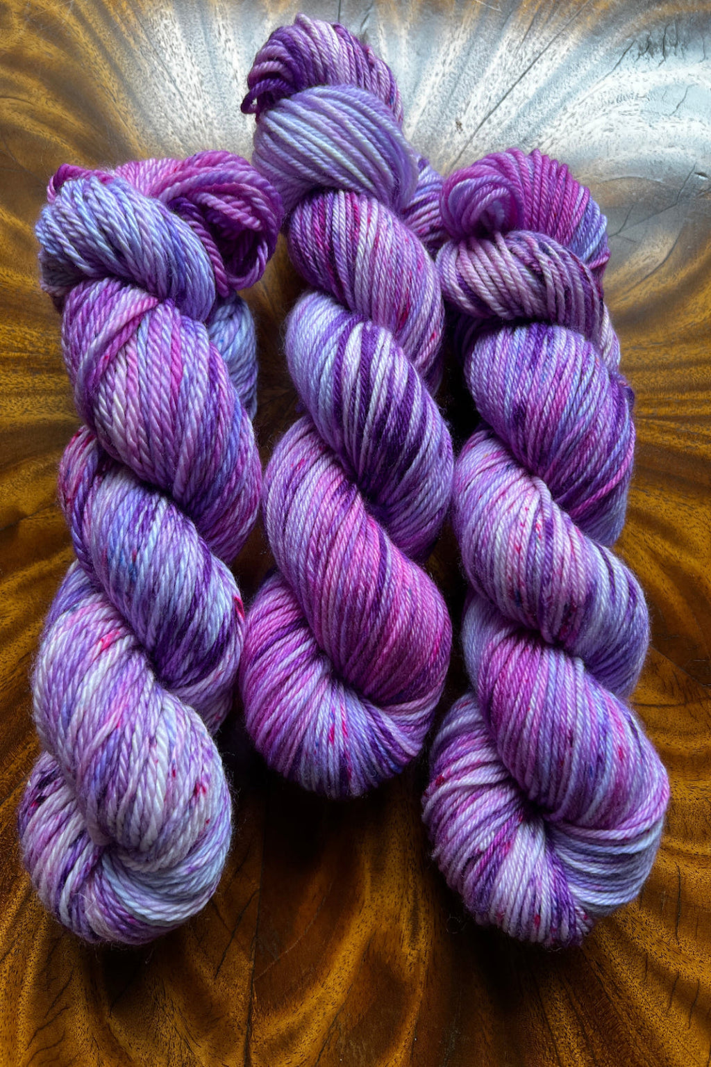 Hand-dyed yarn  in small batches for unique, one-of-a-kind results.  Colorway: lavender, magenta, and purple