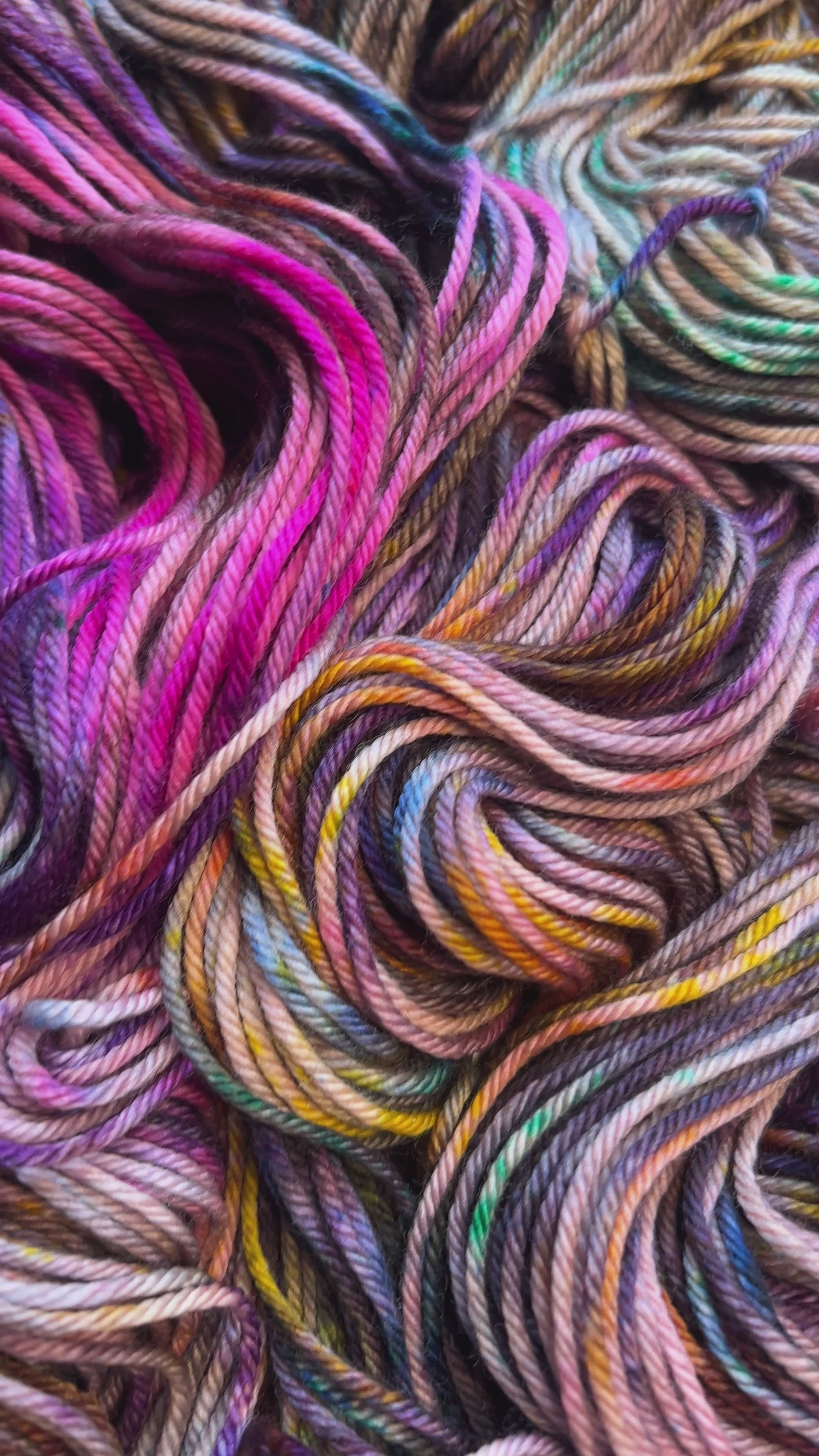 Video of Wild Fig, Painterly air brushed and speckled merino yarn. Hand dyed in shades of brown, hot pink, purple, lavender, golden orange, green and blue.