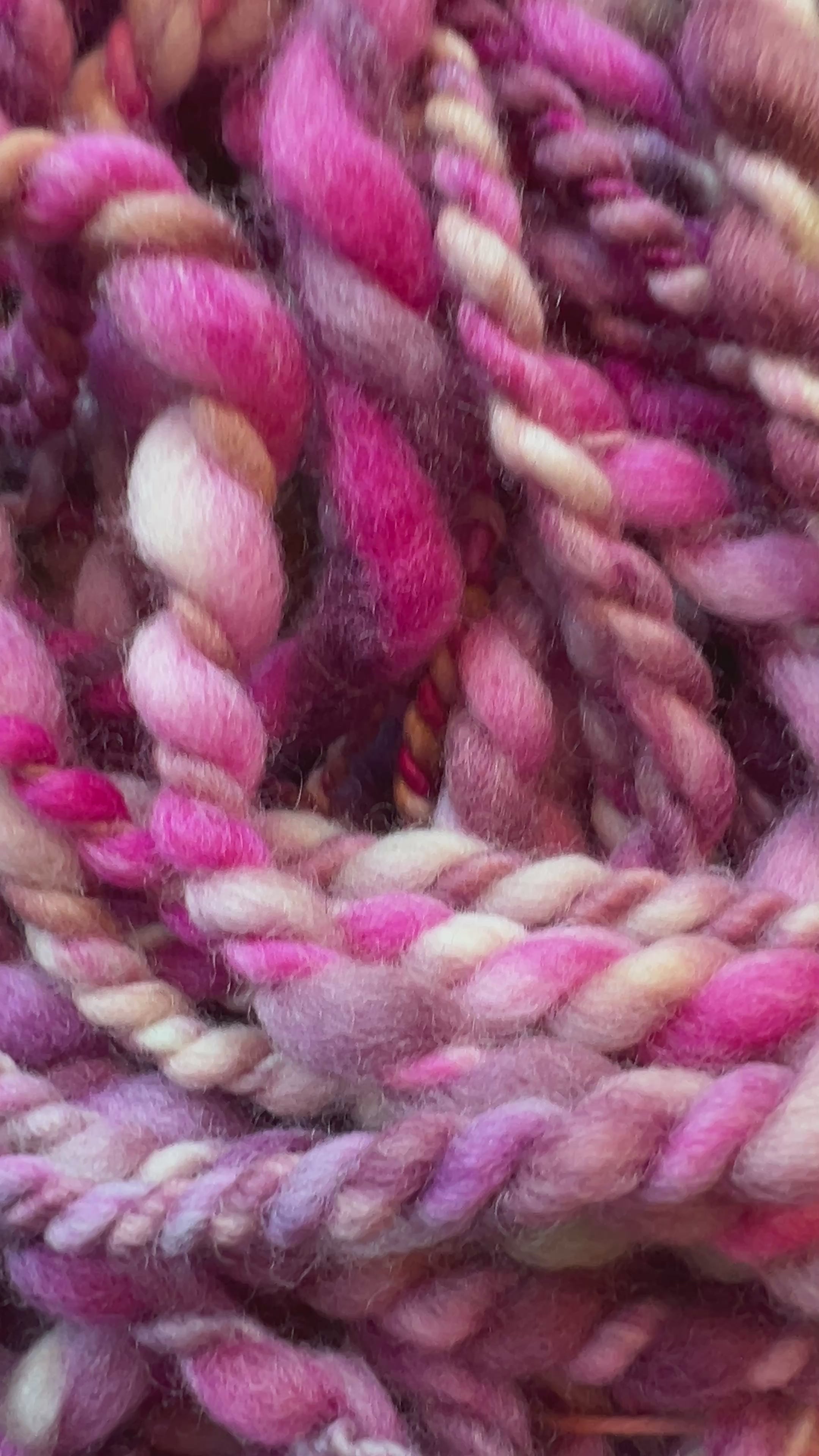 Video of Hand dyed, hand spun in Minneapolis, Orchid Whirl 2 ply art yarn in shades of magenta, purple, lavender and cream.