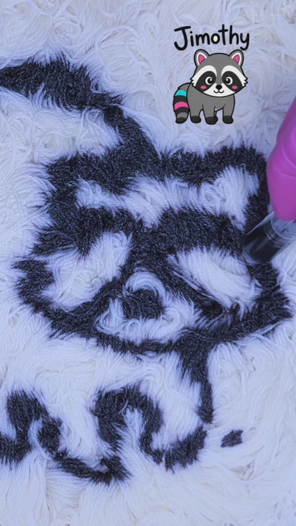 Cute video of Feral Little Jimothy being hand dyed in Minneapolis by Painted Skein. A black and grey Raccoon is painted on to yarn, with layers of pink, peach, and lavender added. 