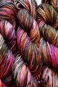 Painterly air brushed and speckled merino yarn. Hand dyed in shades of brown, hot pink, purple, lavender, golden orange, green and blue.
